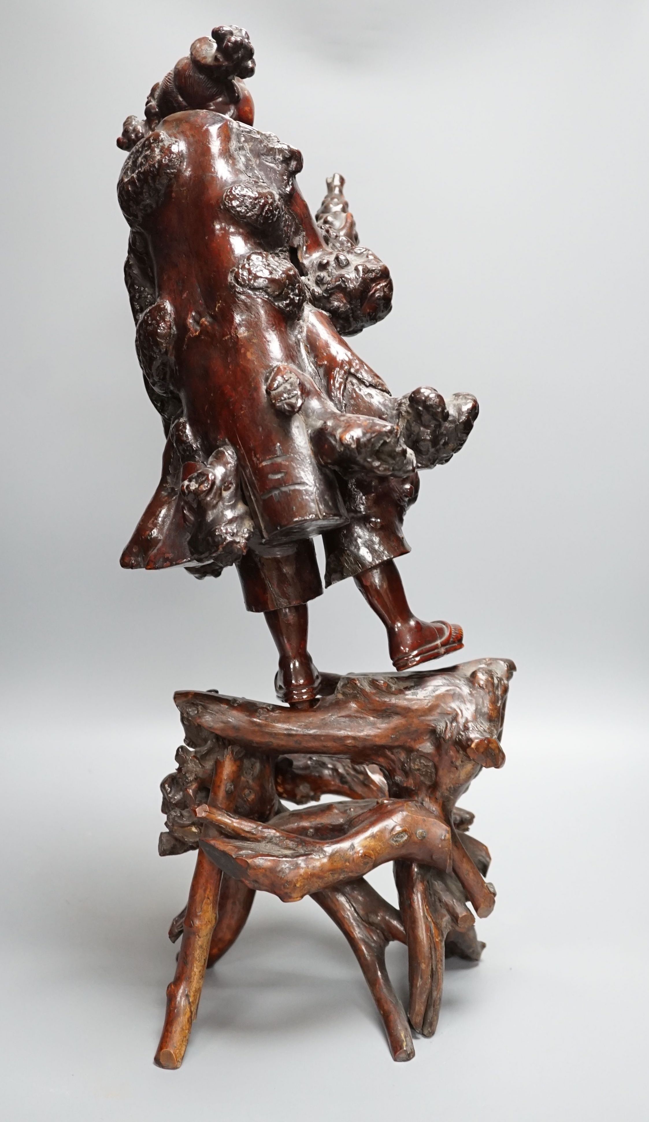 A Chinese root carving of a lady, 57cm
